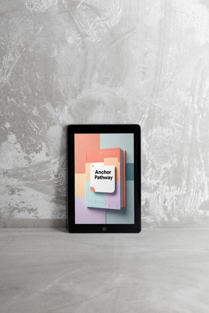 A tablet device standing upright on a light gray surface against a textured gray wall, displaying a colorful cover design with the text 'Anchor Pathway'.