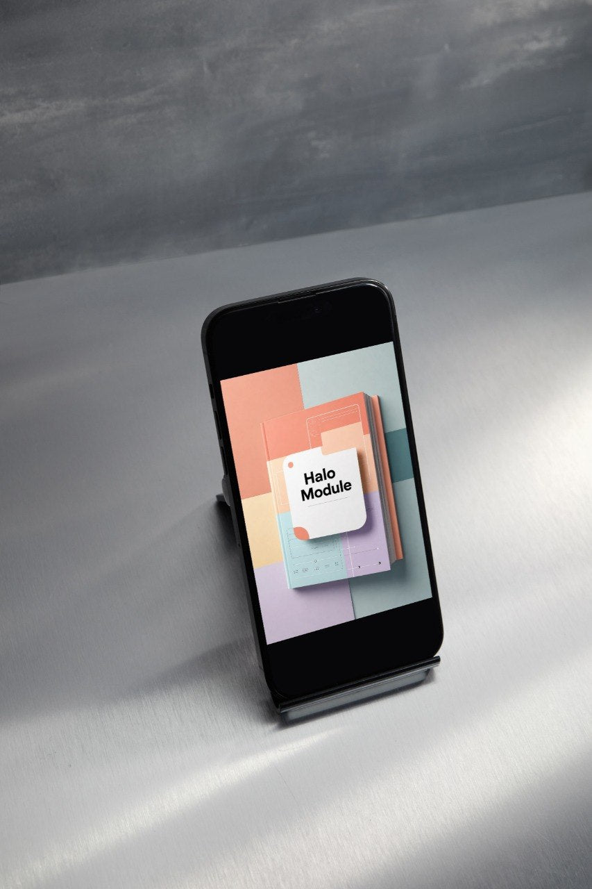 A black smartphone displayed upright on a small stand, showing a colorful app or module screen with the text 'Hello Module' on a neutral gray studio background.