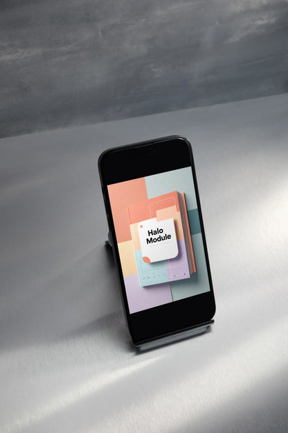 A black smartphone displayed upright on a small stand, showing a colorful app or module screen with the text 'Hello Module' on a neutral gray studio background.